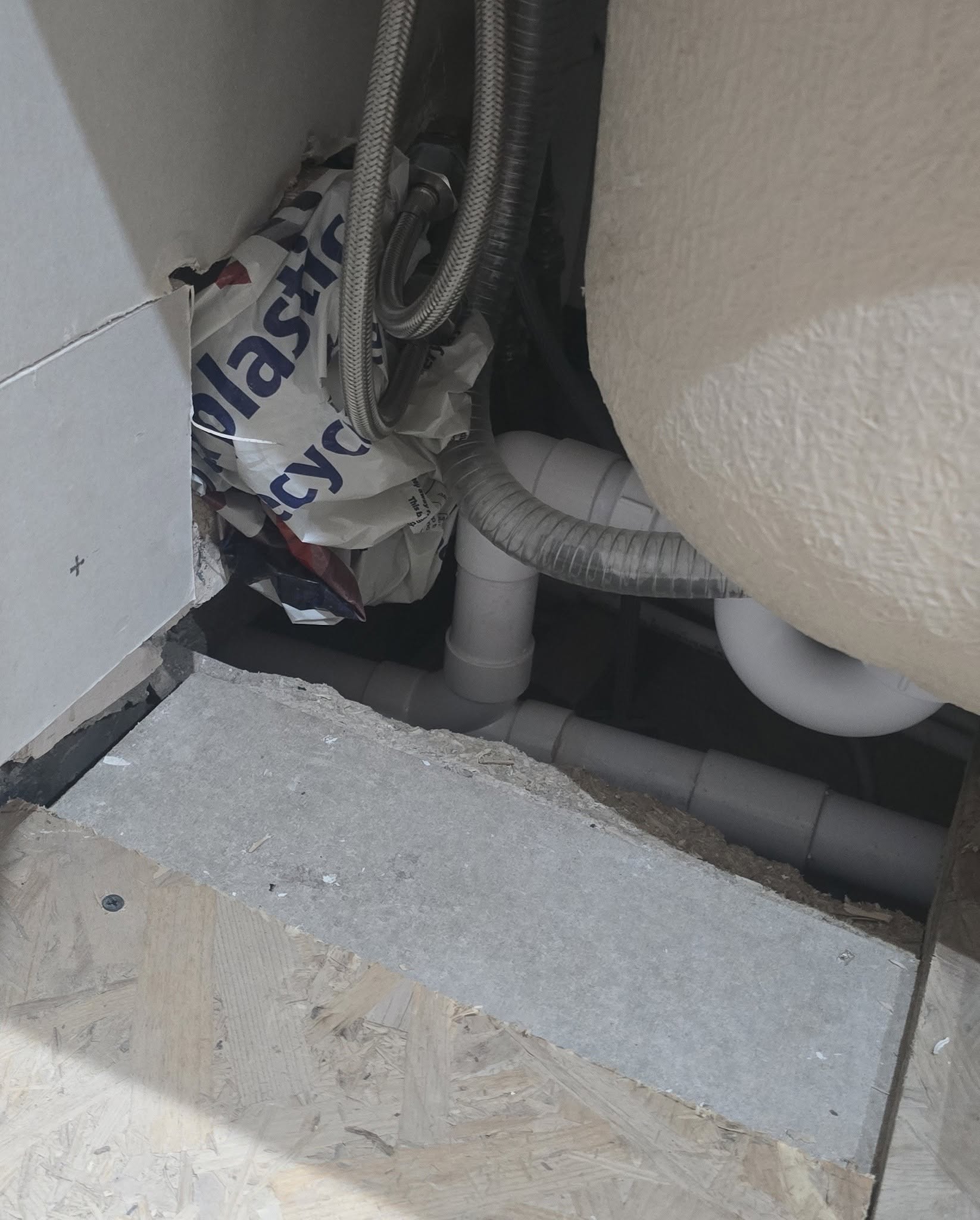 Waste pipework under the bath during the work