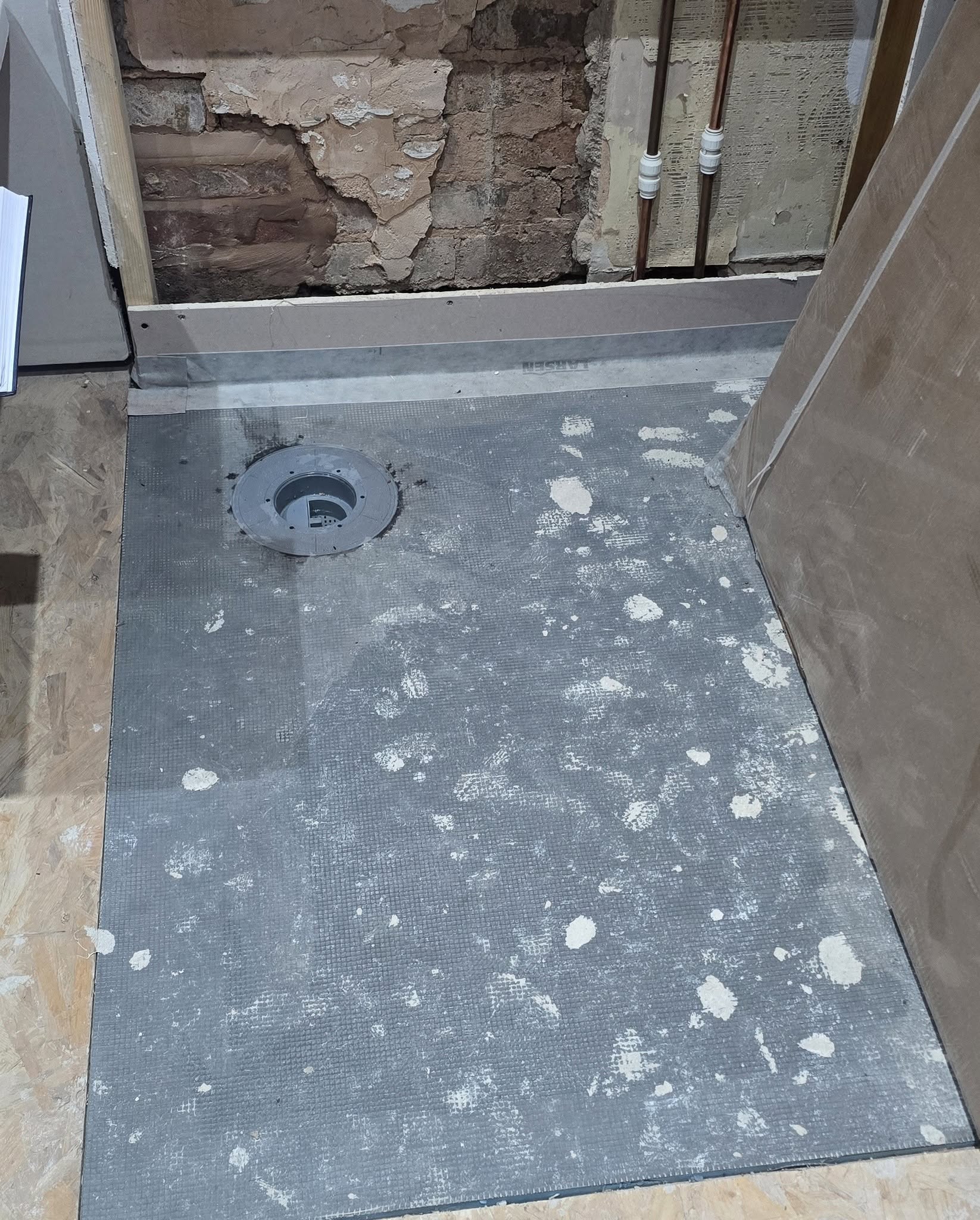 Prepared shower floor with the drain in place, before tiling